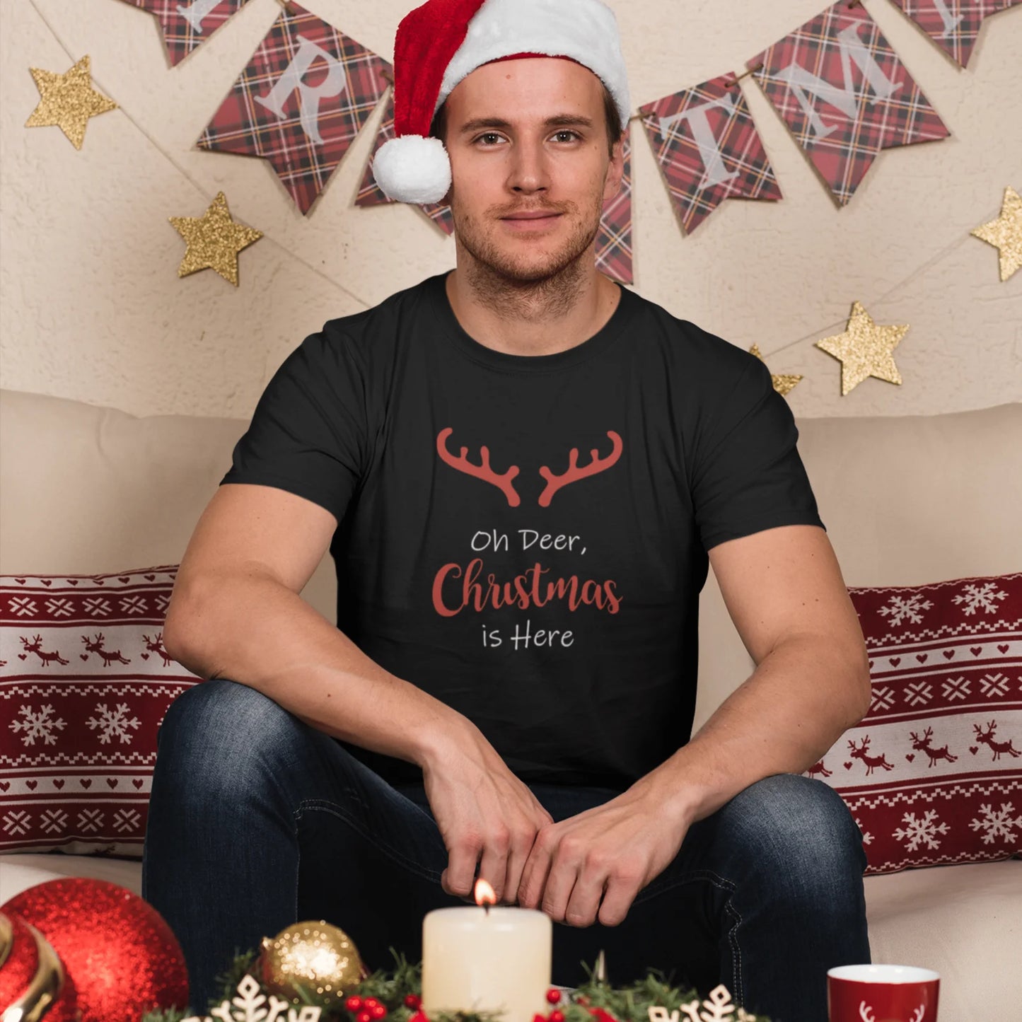 Muž v černém vánočním tričku s nápisem Oh deer Christmasis here 